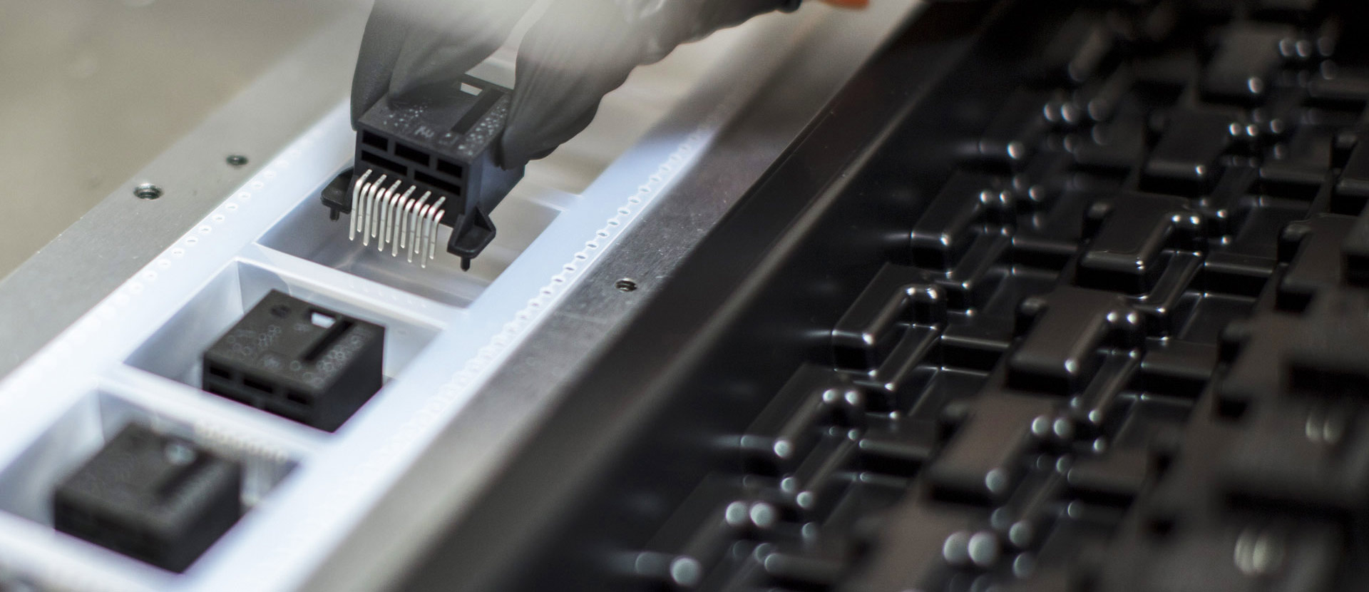 Semiconductor packages transferred from trays into carrier tape